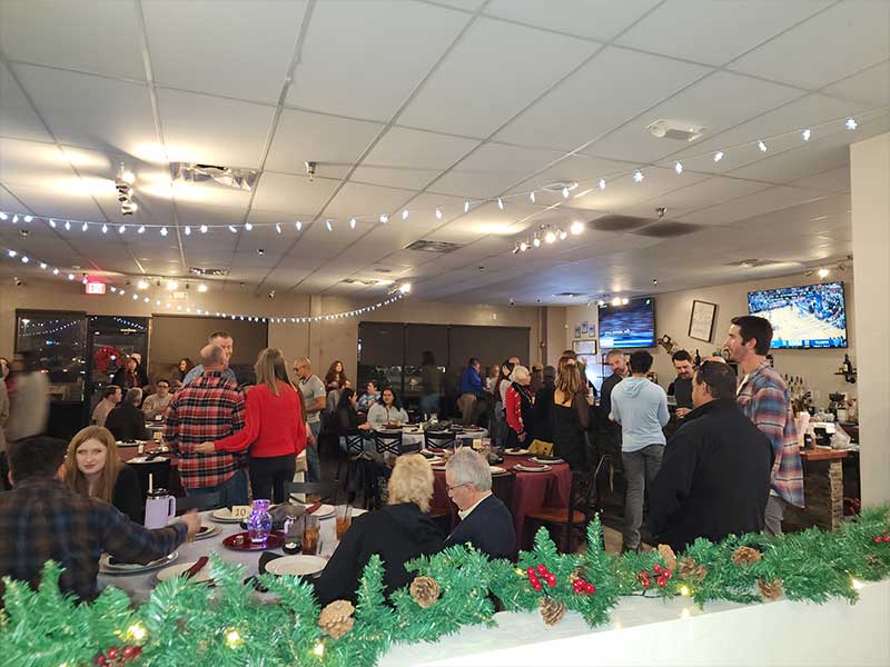 A room full of people at a christmas party.
