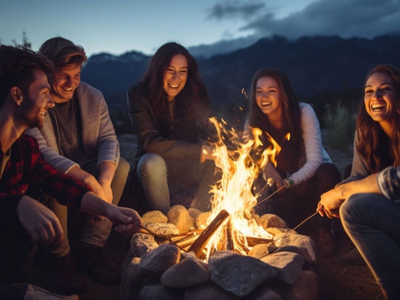 A group of friends sitting around a campfire Sharing Personal Stories.