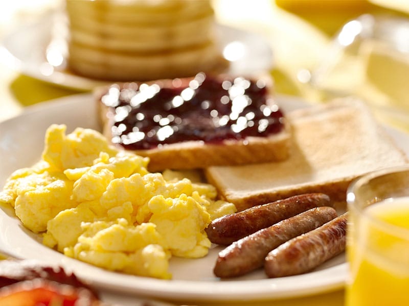A plate of breakfast food on a table.