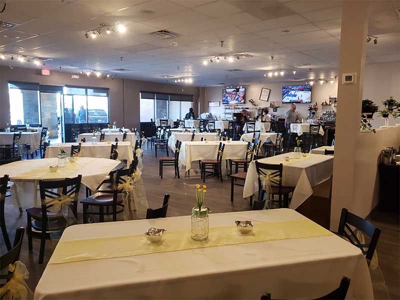 A Tempe breakfast restaurant with tables and chairs set up with yellow table cloths.
