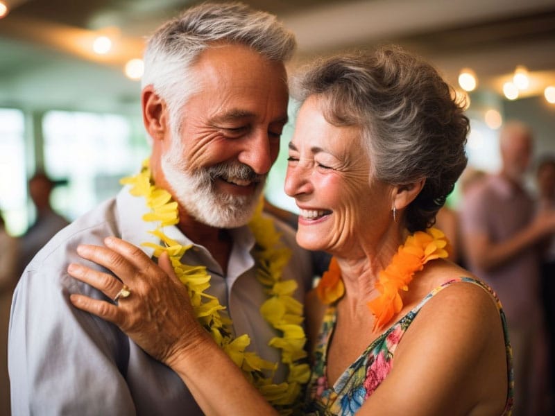 An older couple smiling at each other at a party.