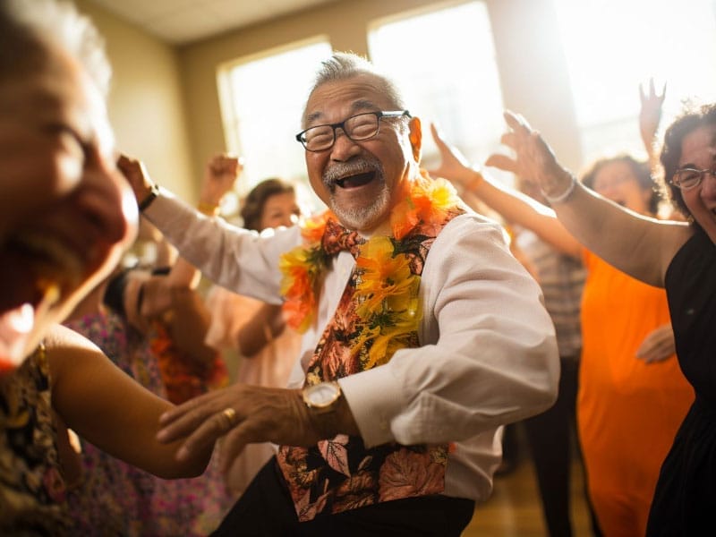 An older man dancing with a group of people.